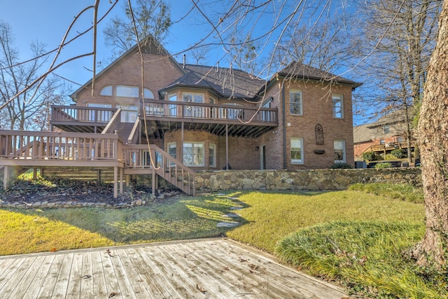 rear view of property with a deck and a yard