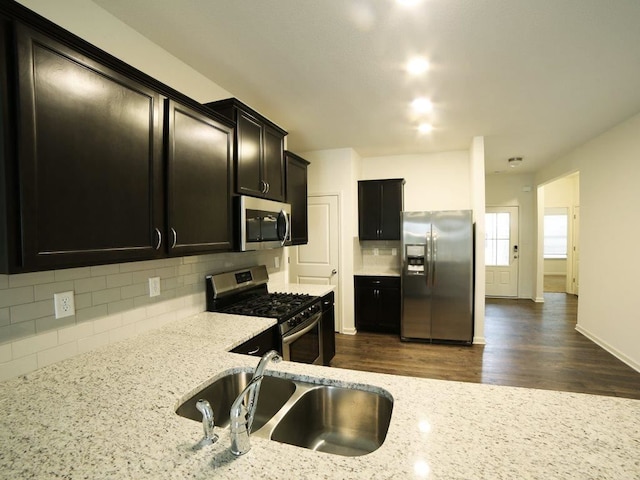 3416 Cecil Moore Dr, Southaven, MS 38671 - kitchen featuring backsplash, light stone counters, appliances with stainless steel finishes, and dark hardwood / wood-style flooring