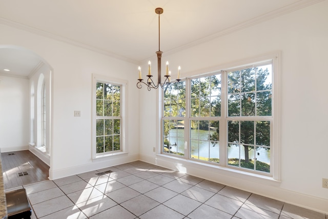 1615 Cedar Lake Cir, Hernando, MS 38632 - unfurnished dining area with an inviting chandelier, plenty of natural light, crown molding, and light tile flooring