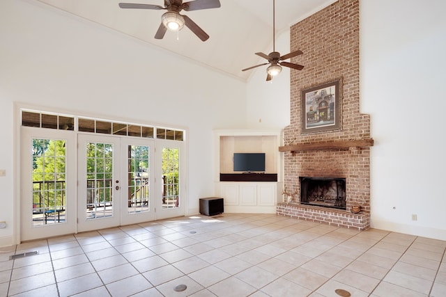 1615 Cedar Lake Cir, Hernando, MS 38632 - unfurnished living room featuring brick wall, a brick fireplace, ceiling fan, light tile floors, and high vaulted ceiling