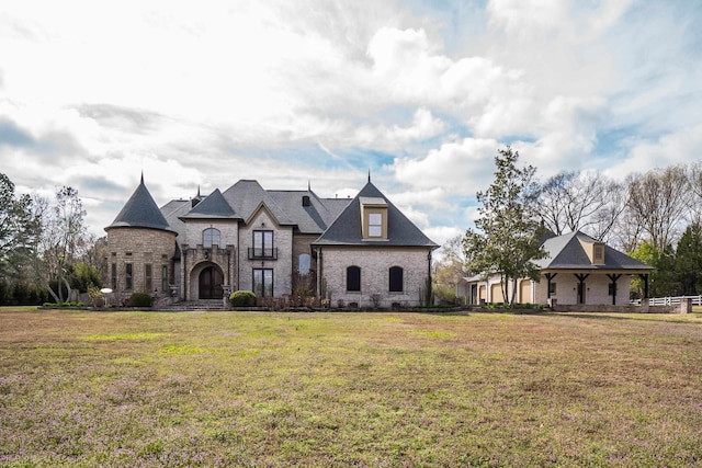 french country inspired facade featuring a front yard