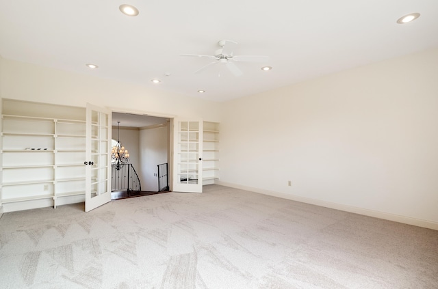 11911 Pete Dr, Collierville, TN 38017 - unfurnished bedroom with french doors, ceiling fan with notable chandelier, and light colored carpet