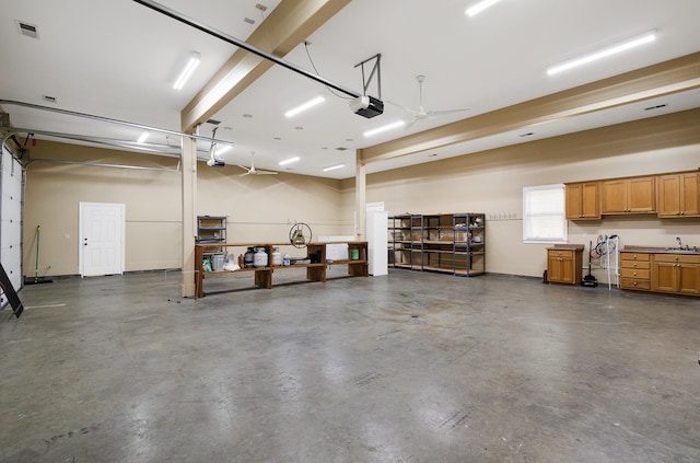 11911 Pete Dr, Collierville, TN 38017 - garage with sink, ceiling fan, and a garage door opener