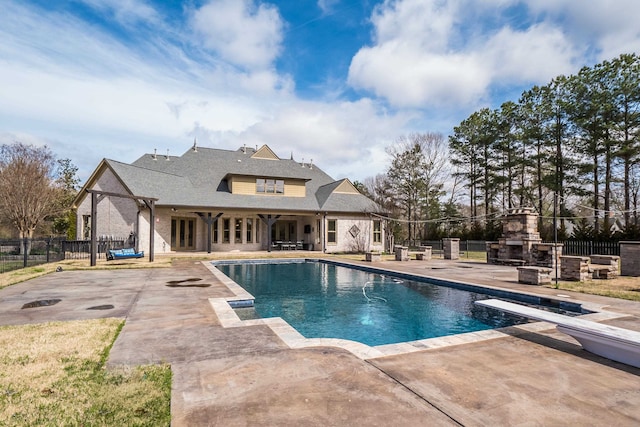 11911 Pete Dr, Collierville, TN 38017 - view of pool featuring exterior fireplace, a diving board, and a patio area