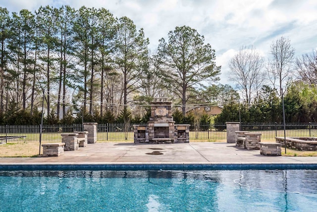 11911 Pete Dr, Collierville, TN 38017 - view of swimming pool featuring an outdoor stone fireplace and a patio