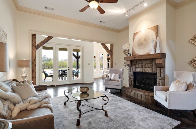 11911 Pete Dr, Collierville, TN 38017 - living room with ceiling fan, crown molding, rail lighting, and a stone fireplace