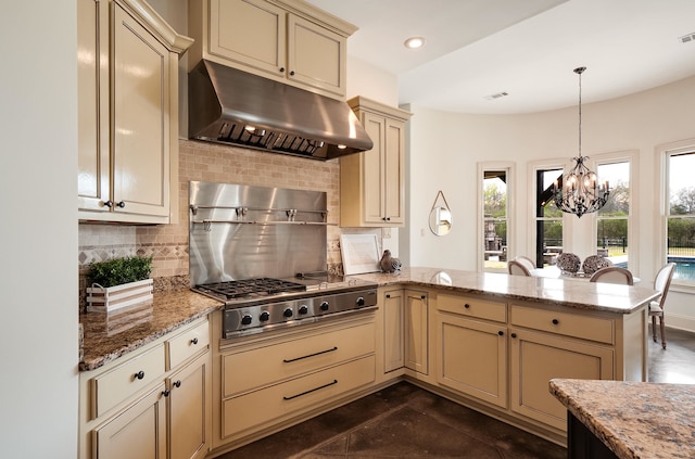 11911 Pete Dr, Collierville, TN 38017 - kitchen with tasteful backsplash, kitchen peninsula, a notable chandelier, light stone countertops, and hanging light fixtures