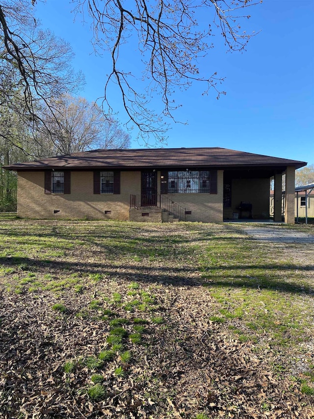 single story home with a front yard and a carport