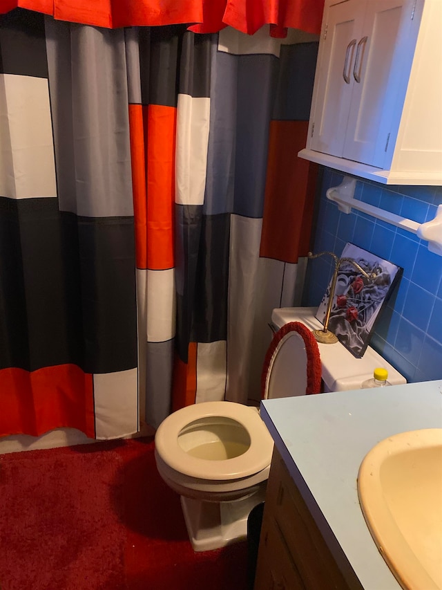 bathroom featuring backsplash, toilet, and vanity