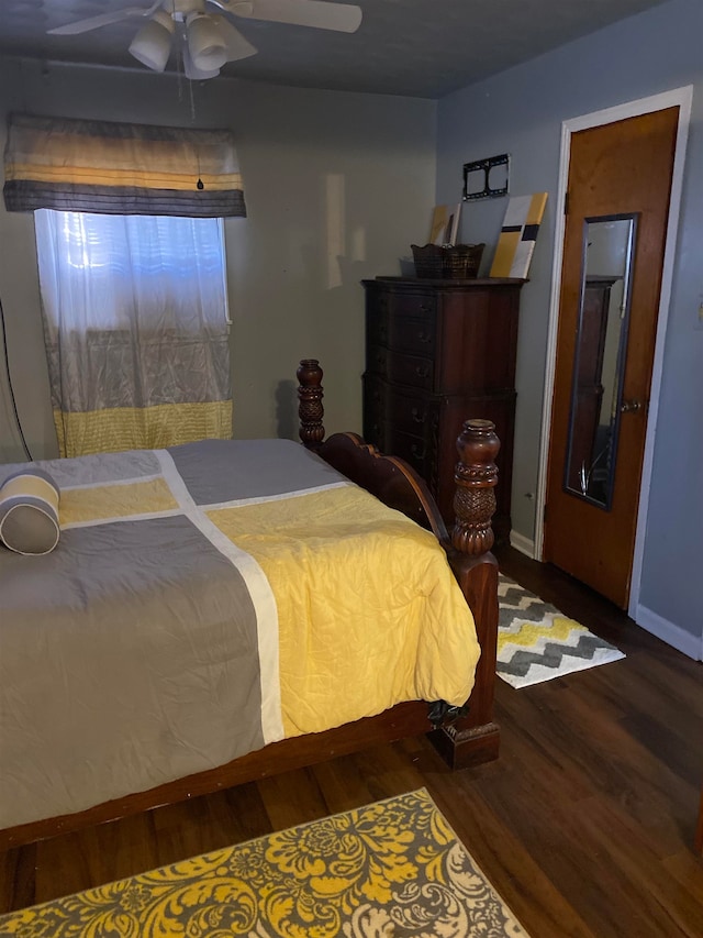 bedroom with ceiling fan and dark wood-type flooring