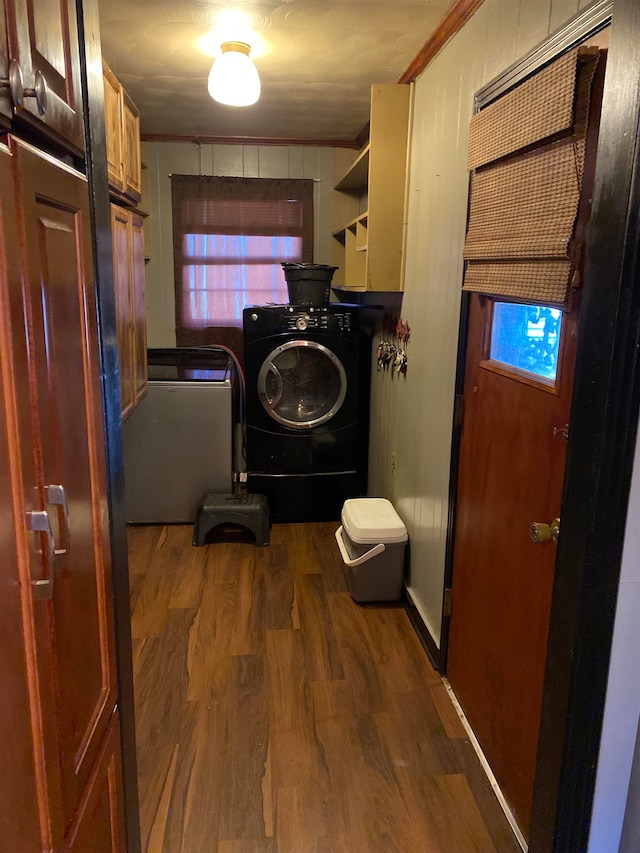 washroom with cabinets, separate washer and dryer, and dark wood-type flooring