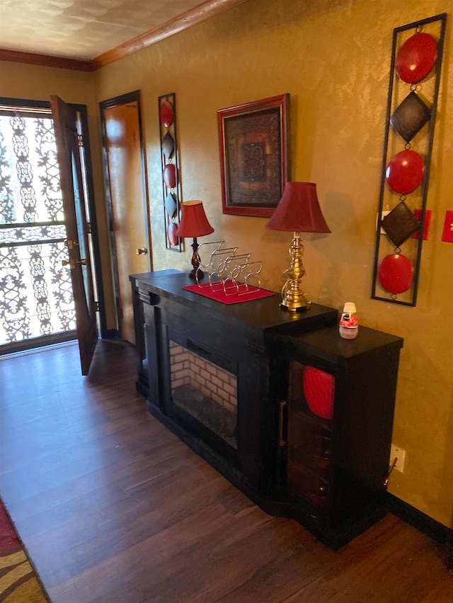 interior space with ornamental molding and dark wood-type flooring