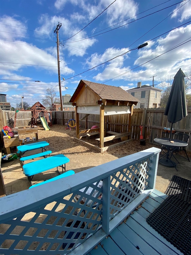 wooden terrace with a playground, a patio area, and a gazebo