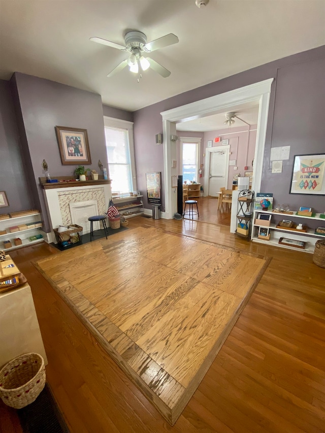 living room featuring ceiling fan and wood-type flooring