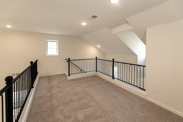 additional living space with lofted ceiling and light colored carpet