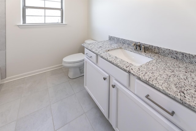 bathroom with vanity, tile patterned floors, and toilet