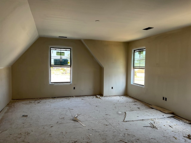 bonus room featuring lofted ceiling and plenty of natural light