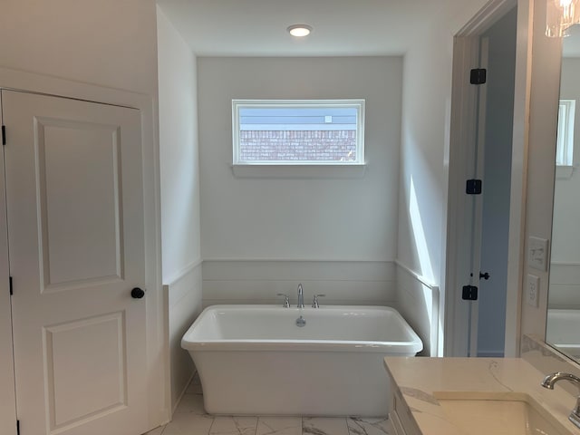 bathroom with vanity and a bathtub