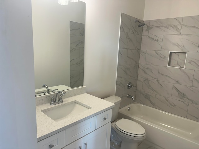 full bathroom with vanity, toilet, and tiled shower / bath