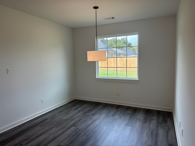 unfurnished room with dark wood-type flooring