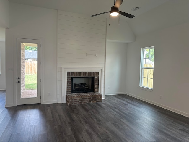 unfurnished living room featuring ceiling fan, dark hardwood / wood-style flooring, high vaulted ceiling, and a healthy amount of sunlight