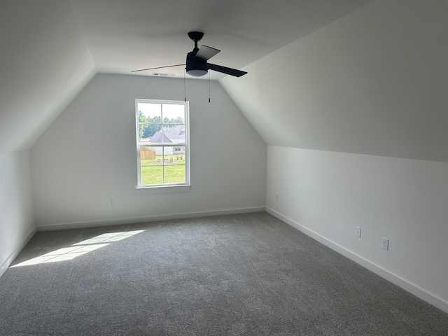 additional living space featuring vaulted ceiling, ceiling fan, and carpet flooring