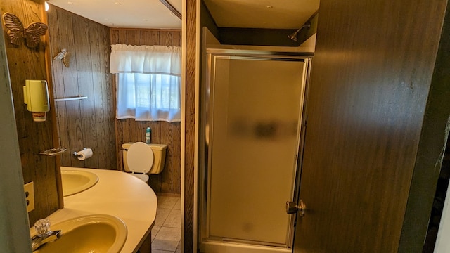 bathroom with vanity, toilet, wooden walls, and an enclosed shower