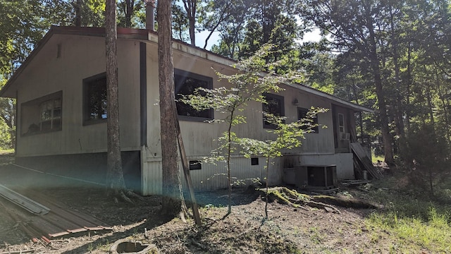 view of side of home with central AC unit