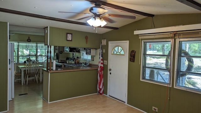 kitchen featuring ceiling fan, lofted ceiling with beams, light wood-type flooring, and electric range oven