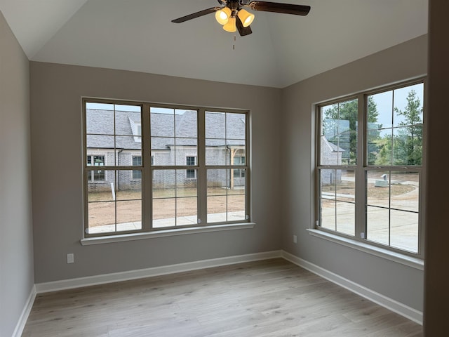 unfurnished room with vaulted ceiling, ceiling fan, and light hardwood / wood-style flooring