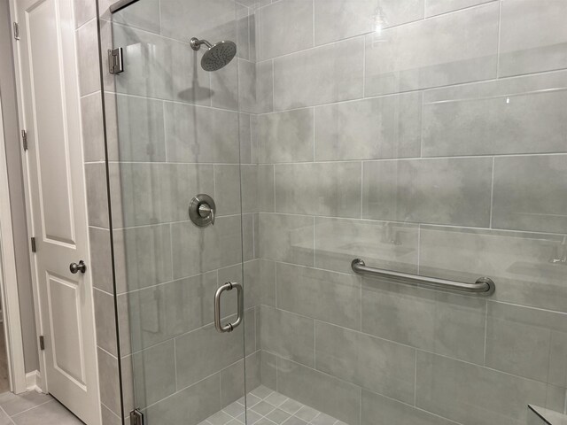 bathroom featuring tile patterned floors and an enclosed shower