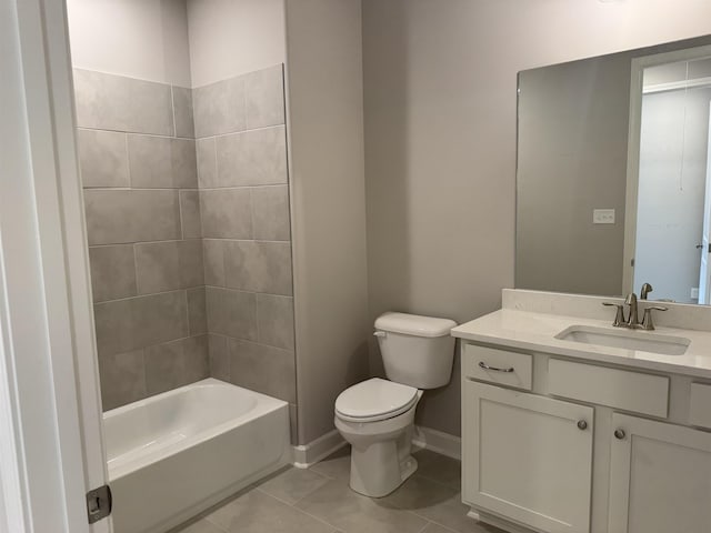 full bathroom with tile patterned flooring, tiled shower / bath, vanity, and toilet