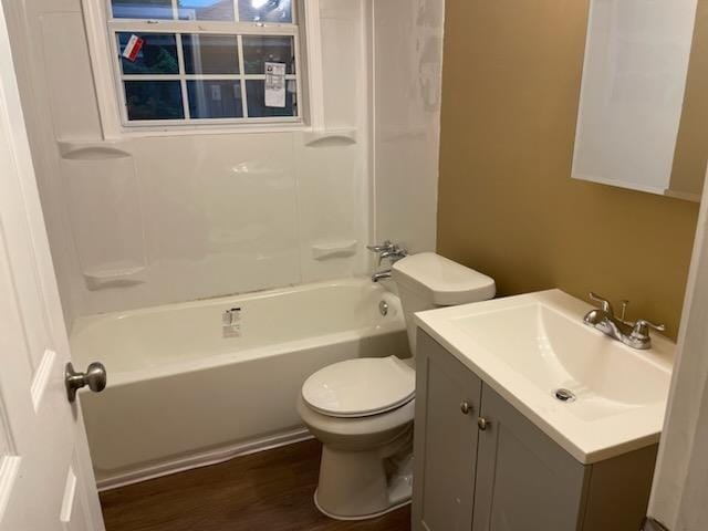 full bathroom with toilet, wood-type flooring, vanity, and shower / tub combination