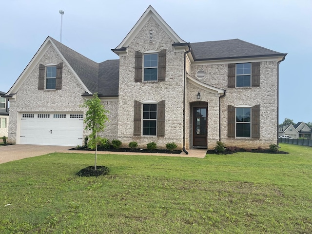 view of front of property featuring a front lawn and a garage