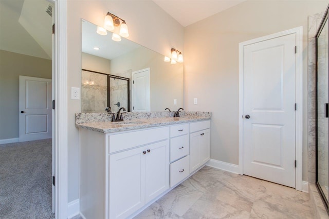 bathroom with dual sinks, tile floors, large vanity, and a shower with shower door