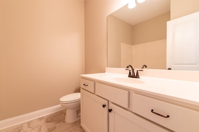 bathroom featuring tile floors, toilet, and vanity