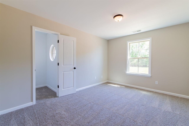 spare room with light colored carpet