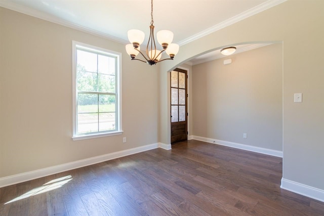 unfurnished room with plenty of natural light, a notable chandelier, and dark hardwood / wood-style floors