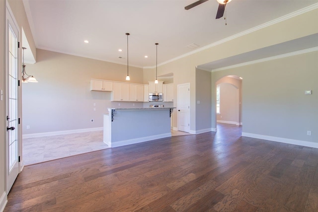 kitchen featuring decorative light fixtures, ceiling fan, white cabinetry, and dark wood-type flooring