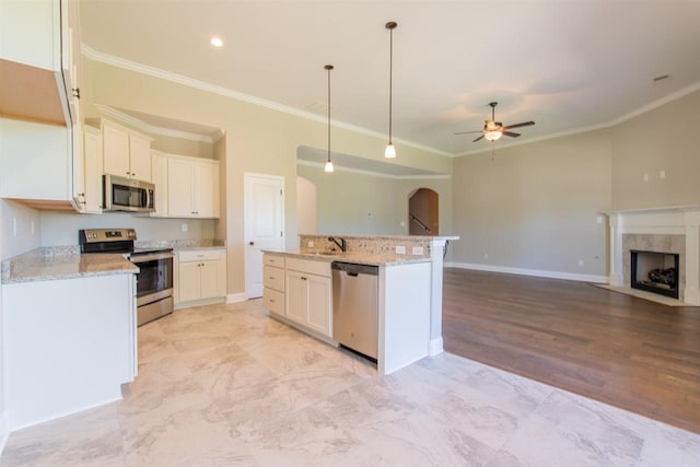 kitchen featuring appliances with stainless steel finishes, light stone counters, light wood-type flooring, a kitchen island with sink, and ceiling fan