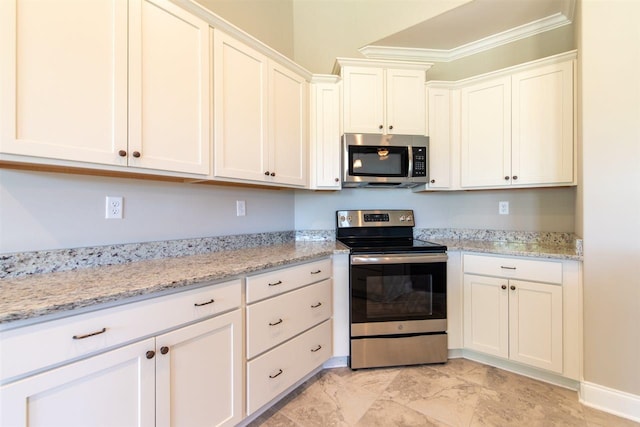 kitchen with light stone counters, white cabinets, light tile floors, stainless steel appliances, and ornamental molding