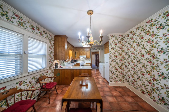 tiled dining area with ornamental molding, a notable chandelier, and sink