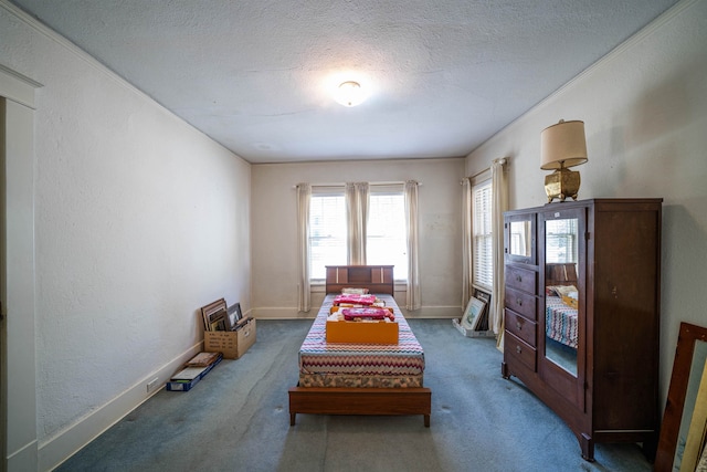 bedroom featuring a textured ceiling and dark carpet