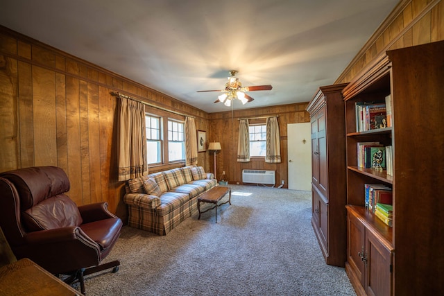 living room featuring ceiling fan, wood walls, carpet flooring, and an AC wall unit