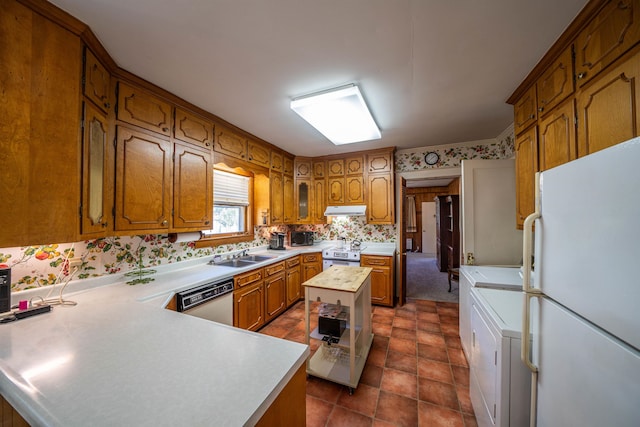 kitchen with a kitchen island, range with electric cooktop, white refrigerator, washer and dryer, and dishwashing machine