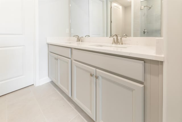 bathroom with walk in shower, vanity, and tile patterned flooring