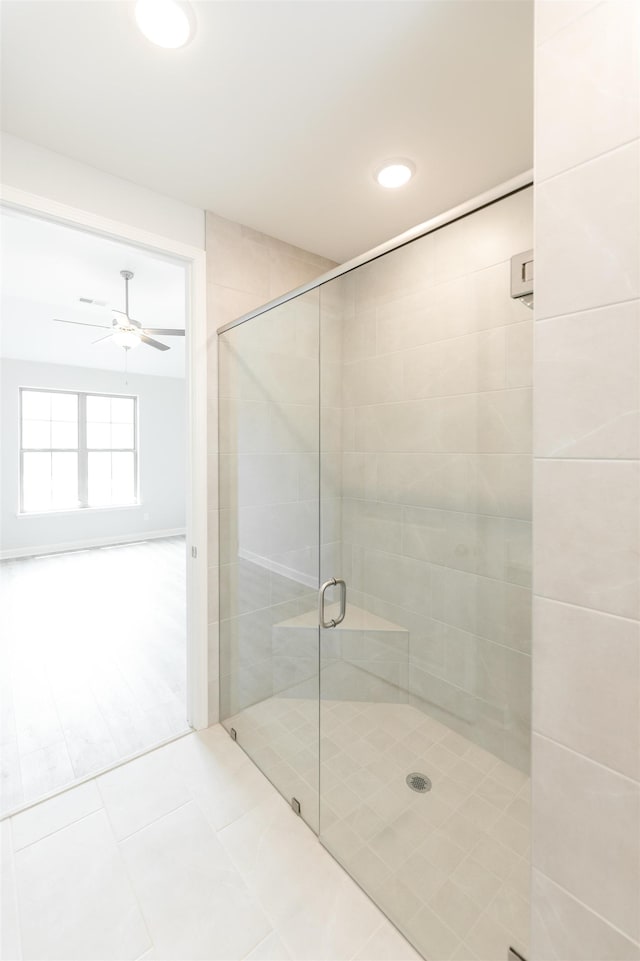 bathroom featuring walk in shower, ceiling fan, and tile patterned flooring