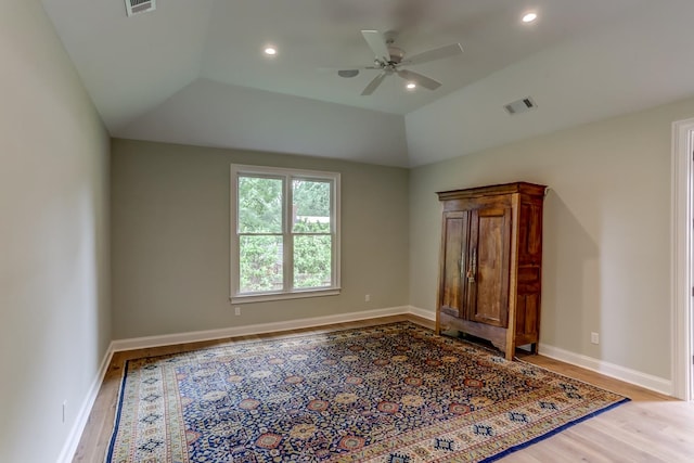 unfurnished bedroom featuring light hardwood / wood-style floors, ceiling fan, and lofted ceiling