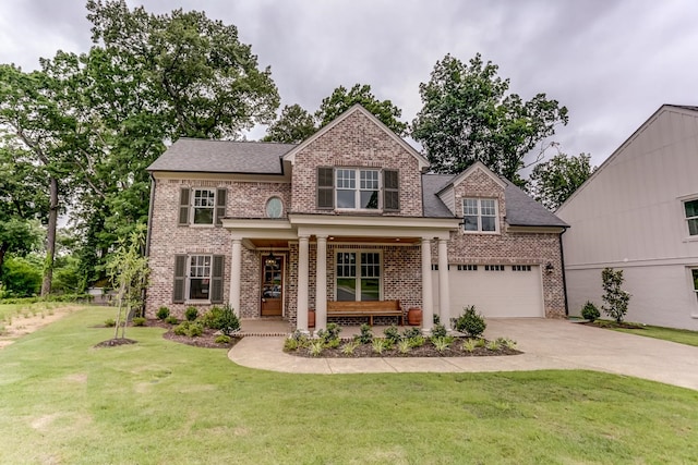 view of front facade with a front lawn, a porch, and a garage