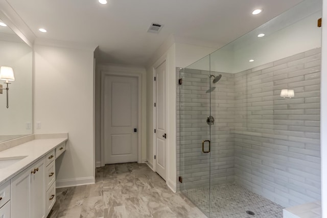 bathroom with ornamental molding, tile floors, an enclosed shower, and vanity